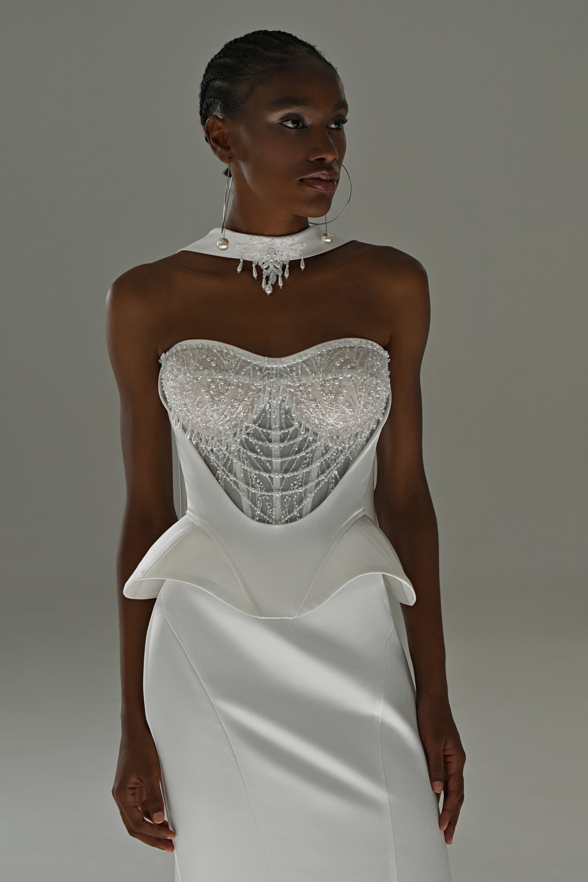 Soft satin mermaid wedding dress – close-up of the lace corset bodice and peplum waist