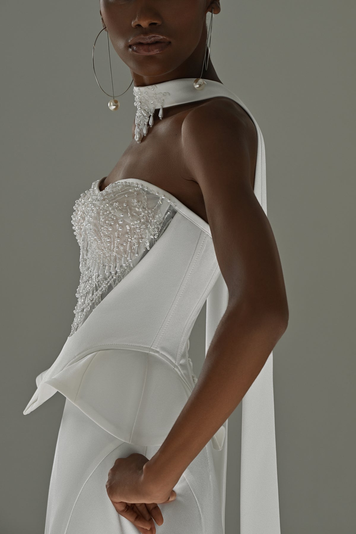 Soft satin mermaid wedding dress – side close-up of the peplum waist and sheer scarf
