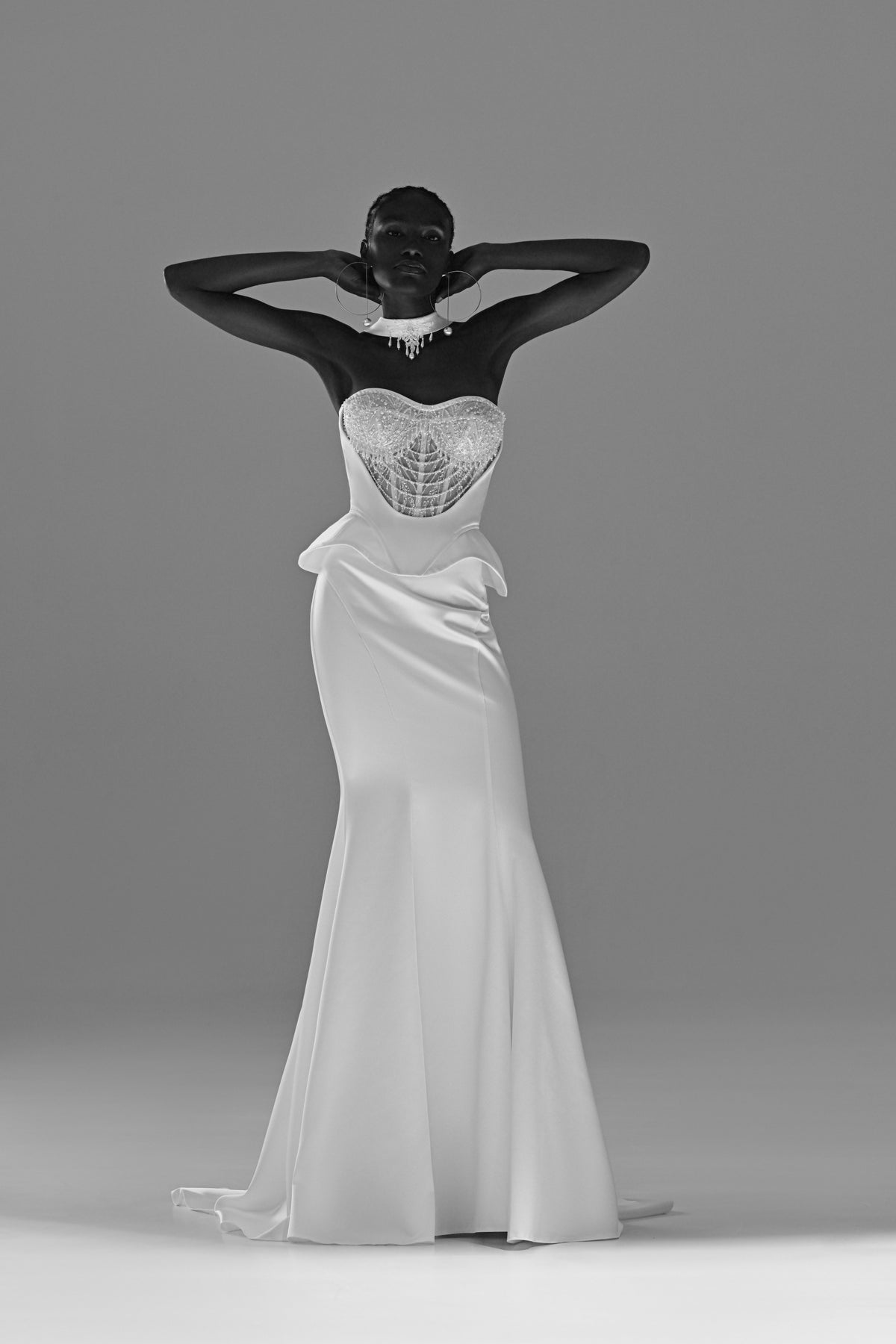 Soft satin mermaid wedding dress with lace corset – black and white front view, hands behind the head