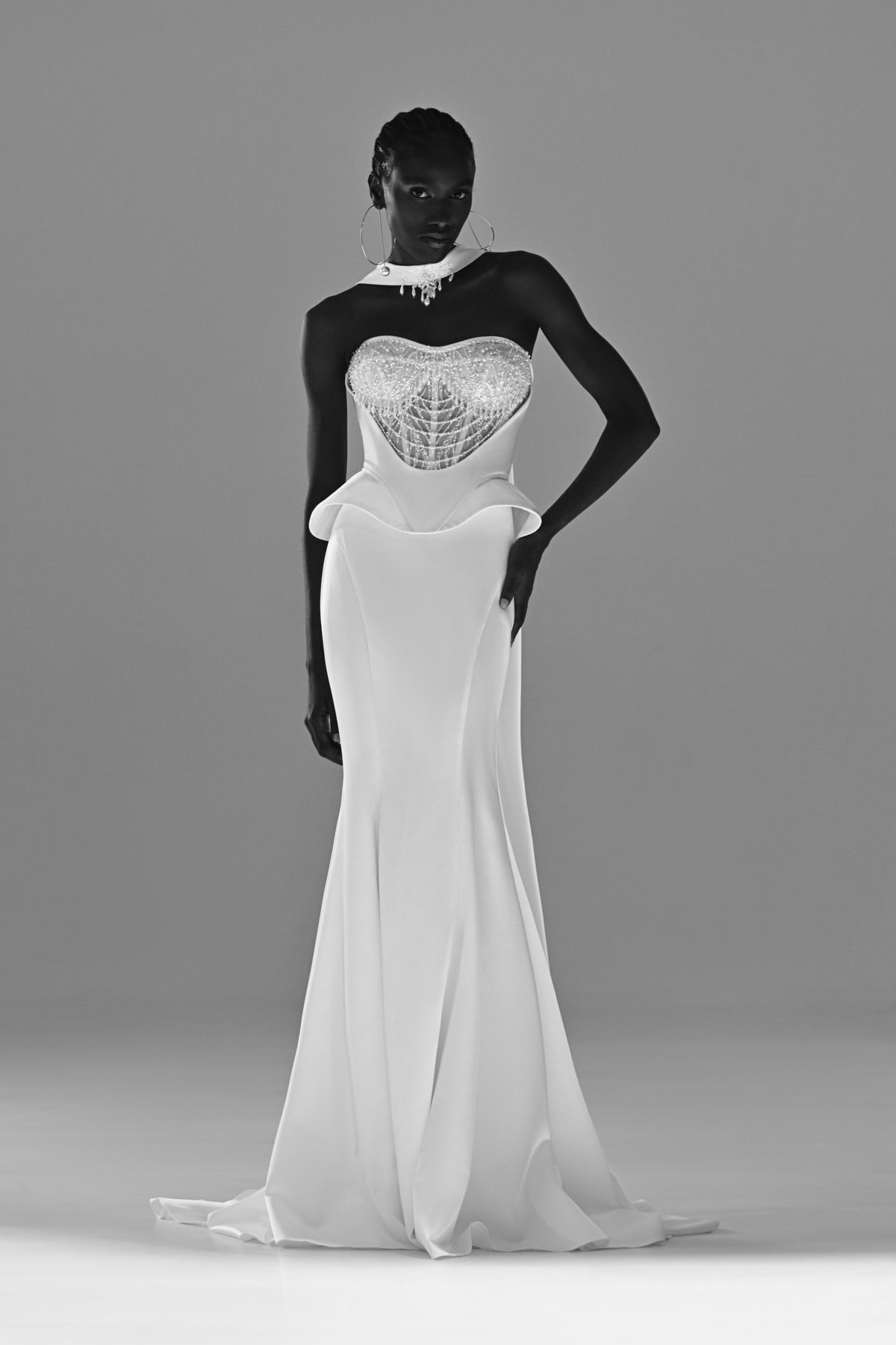 Soft satin mermaid wedding dress with peplum waist – black and white front view, hand on hip