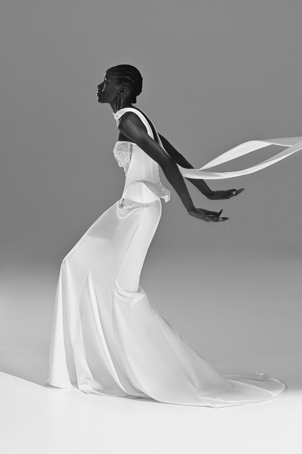 Soft satin mermaid wedding dress – black and white side view with the sheer scarf in motion