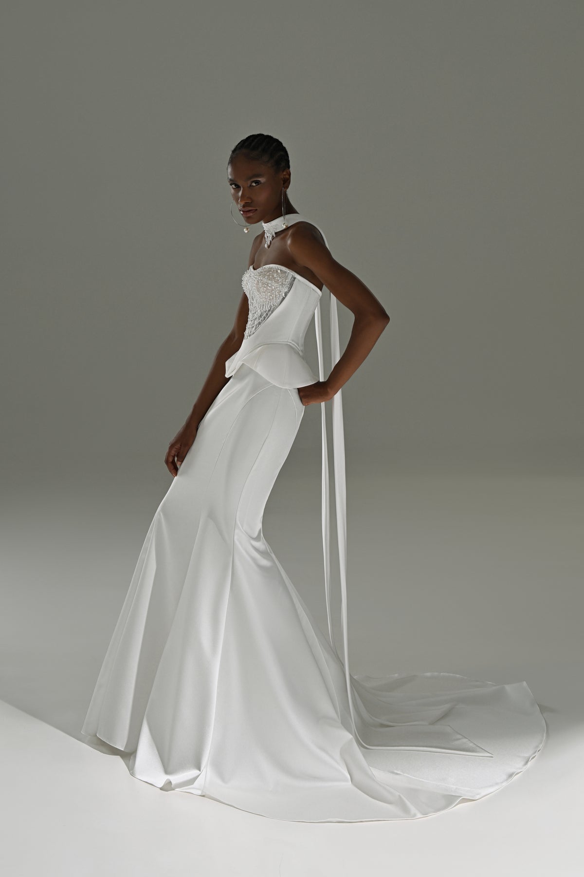 Soft satin mermaid wedding dress with sheer scarf – three-quarter view of the fitted satin skirt and train