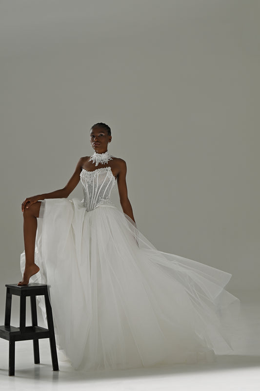 Tulle ball gown wedding dress with strapless lace corset – model with one foot on a stool, tulle skirt spread out