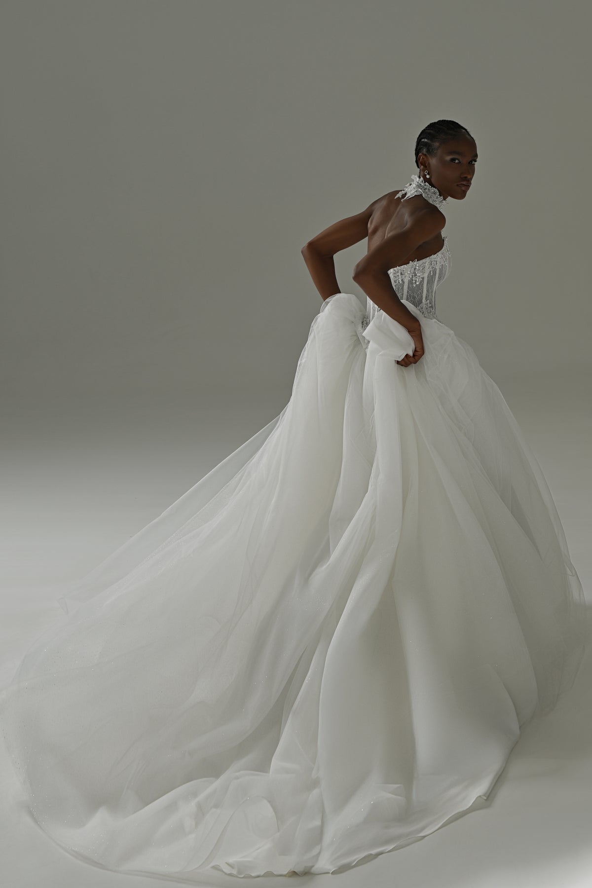 Tulle ball gown wedding dress – side view leaning forward with the tulle train spread behind