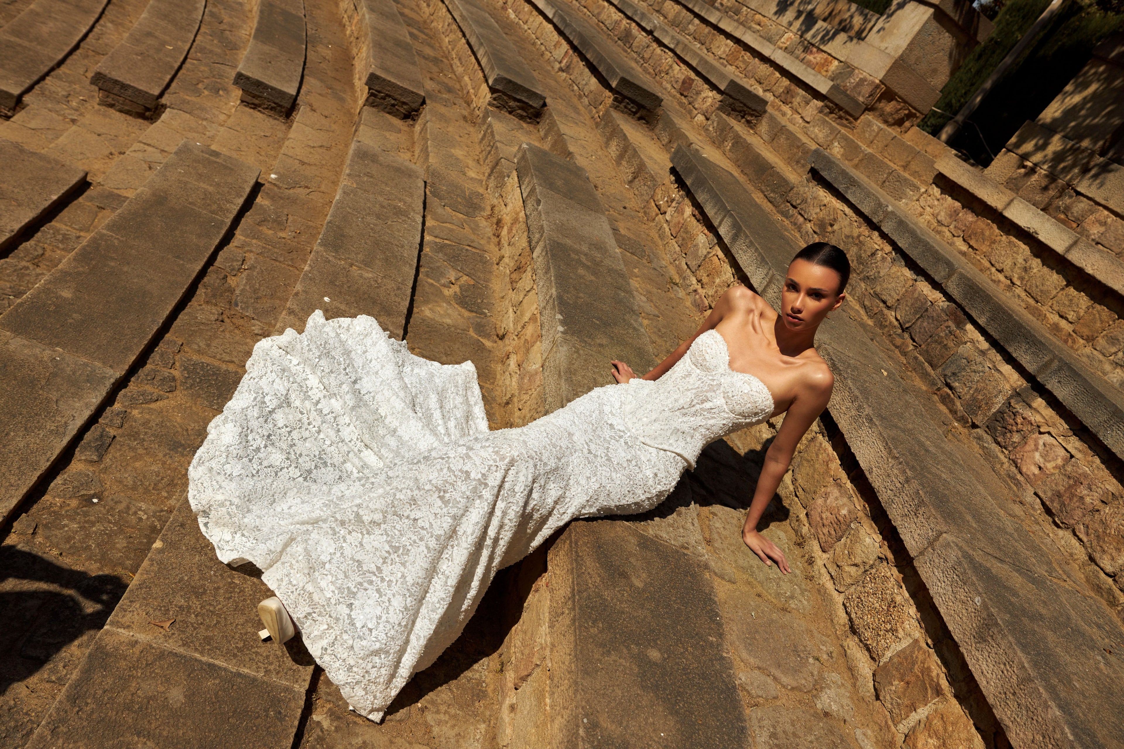 Mermaid wedding dress with sweetheart neckline, sleeveless pearl lace corset, longline bodice, and fishtail court train. Luxurious modern bridal gown.