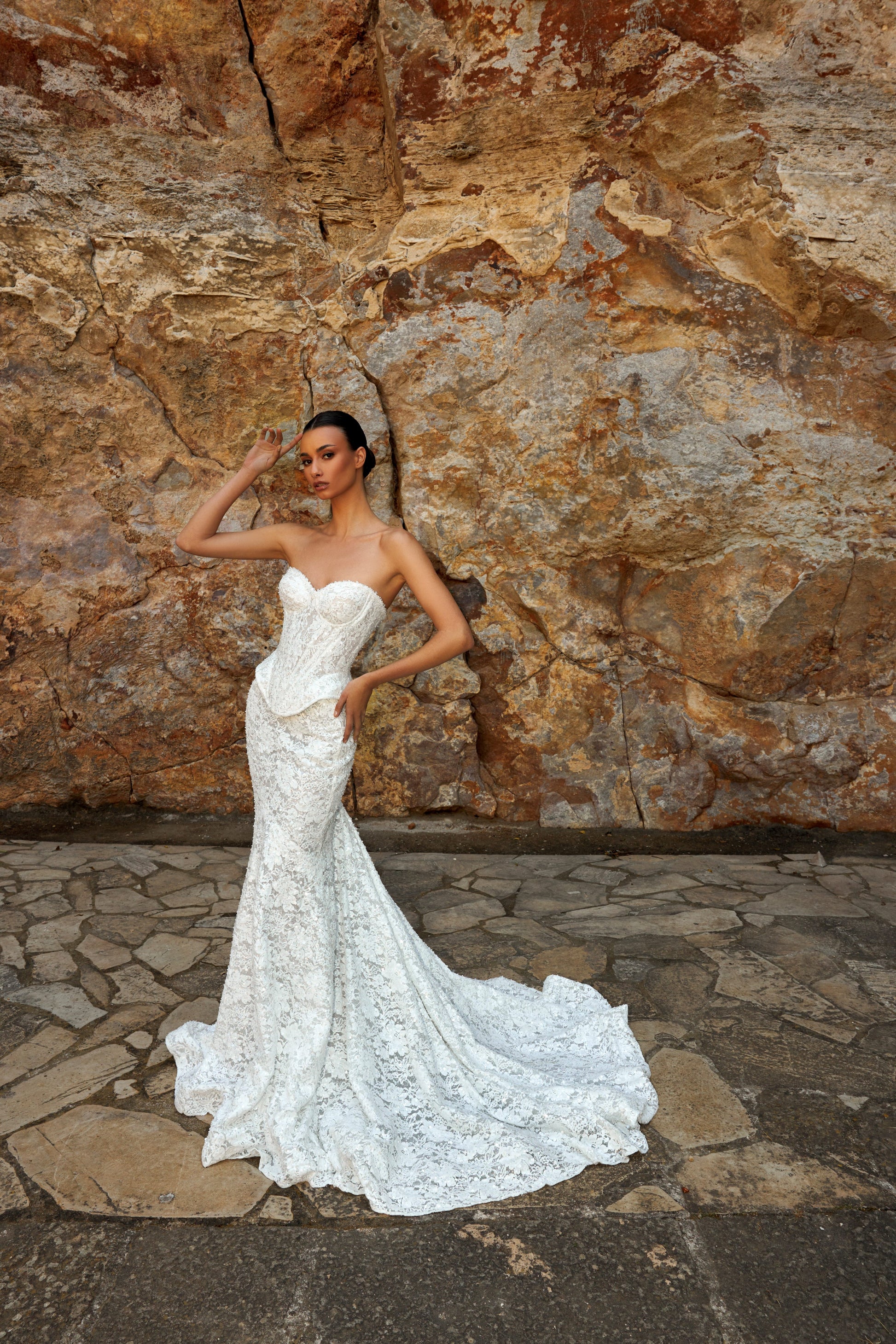 Mermaid wedding dress with sweetheart neckline, sleeveless pearl lace corset, longline bodice, and fishtail court train. Luxurious modern bridal gown.
