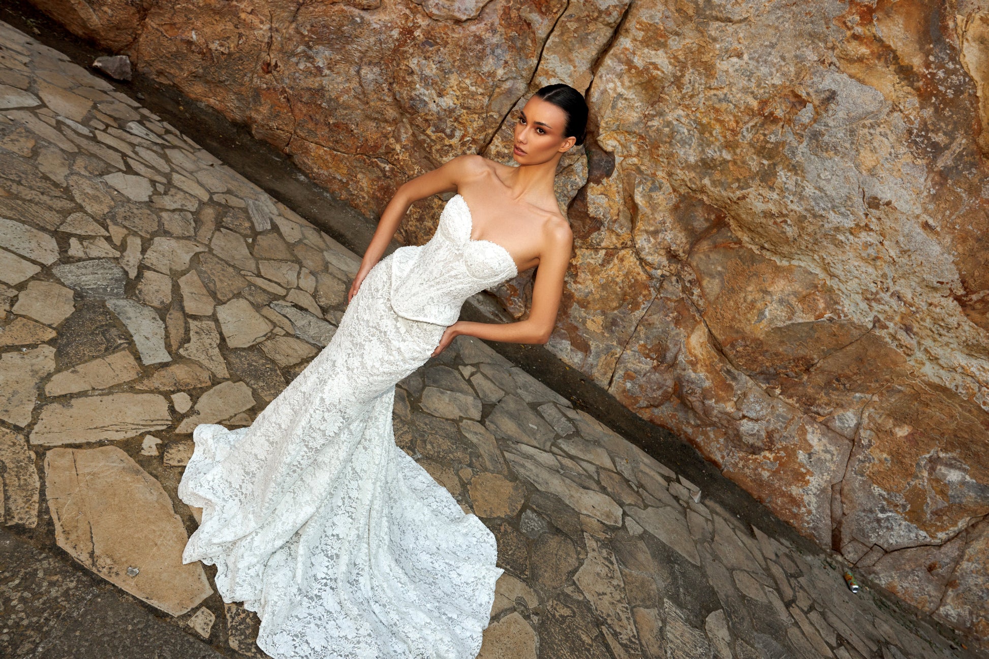 Mermaid wedding dress with sweetheart neckline, sleeveless pearl lace corset, longline bodice, and fishtail court train. Luxurious modern bridal gown.