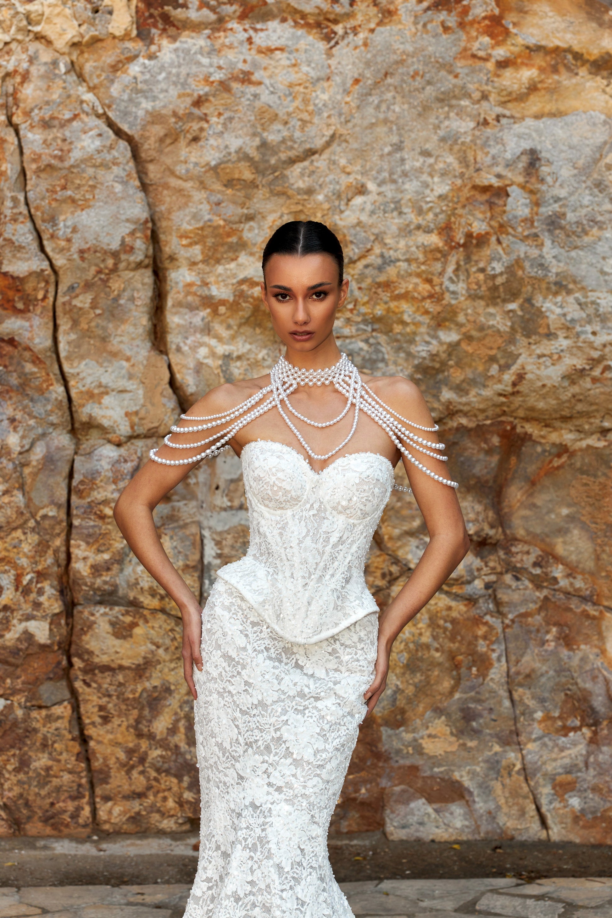 Mermaid wedding dress with sweetheart neckline, sleeveless pearl lace corset, longline bodice, and fishtail court train. Luxurious modern bridal gown.