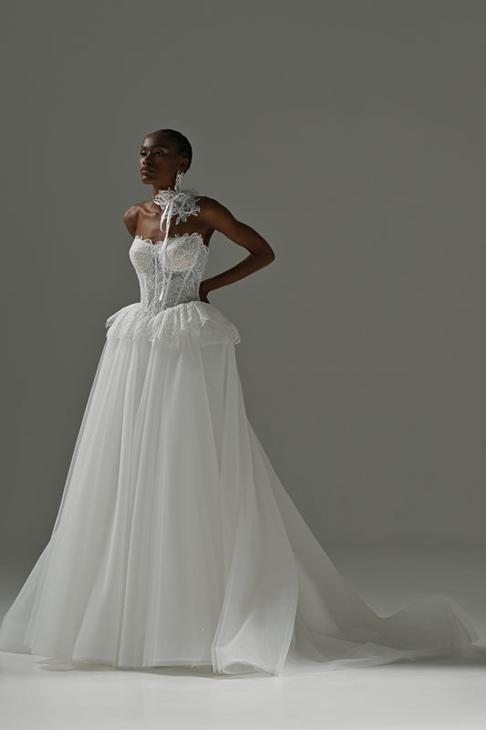 Strapless lace corset wedding dress with peplum waist and full tulle skirt – full-length front view, hands on hips