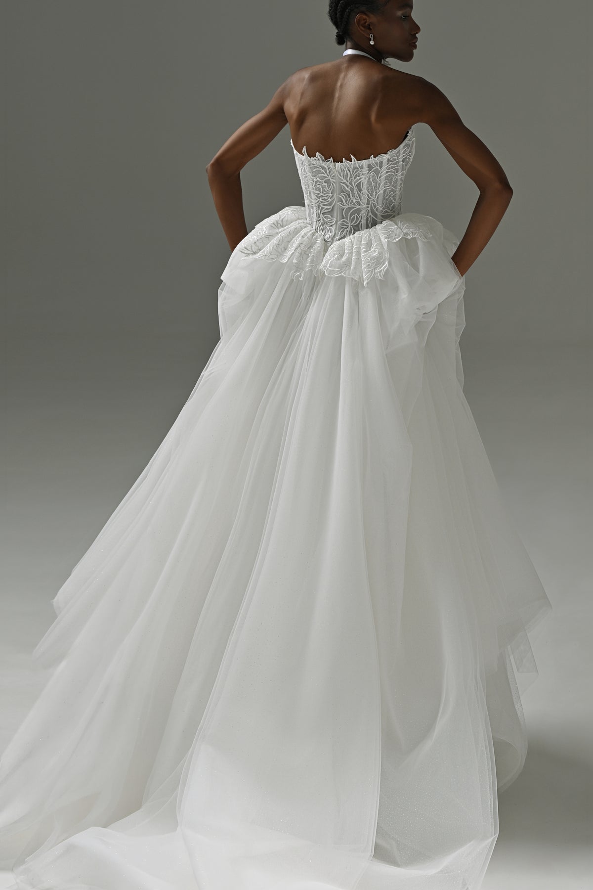 Lace corset wedding dress with peplum waist – back view of the bow and layered tulle skirt