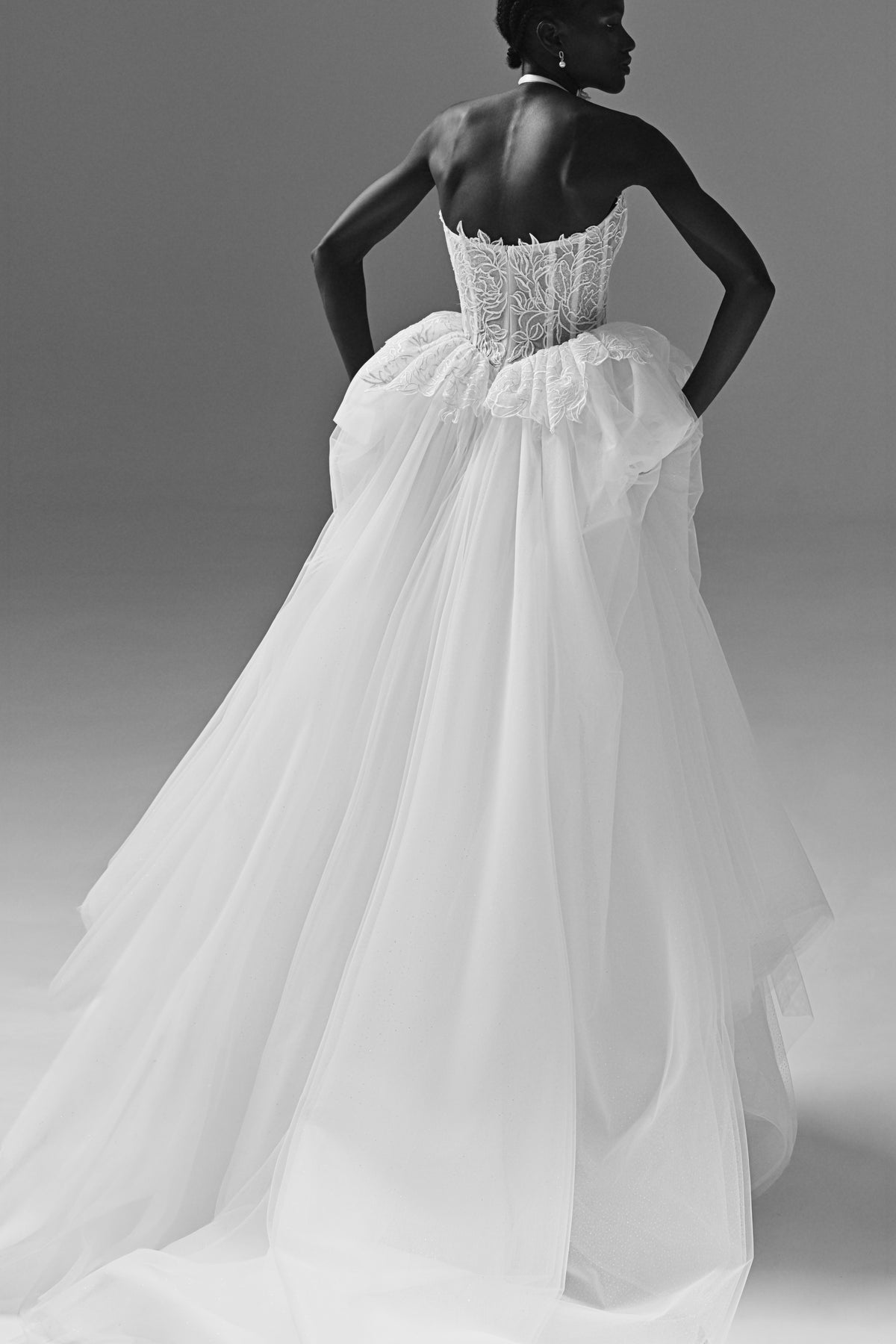 Lace corset wedding dress with peplum waist – black and white back view of the tulle skirt