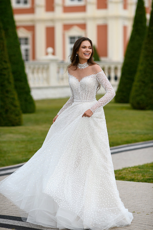 A-line Long illusion off the shoulder sleeves Illusion V-neck Mockneck Open illusion button closed back All gliitter tulle Wedding dress