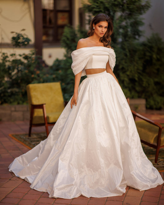 Two-piece A-line wedding dress with off-the-shoulder top.