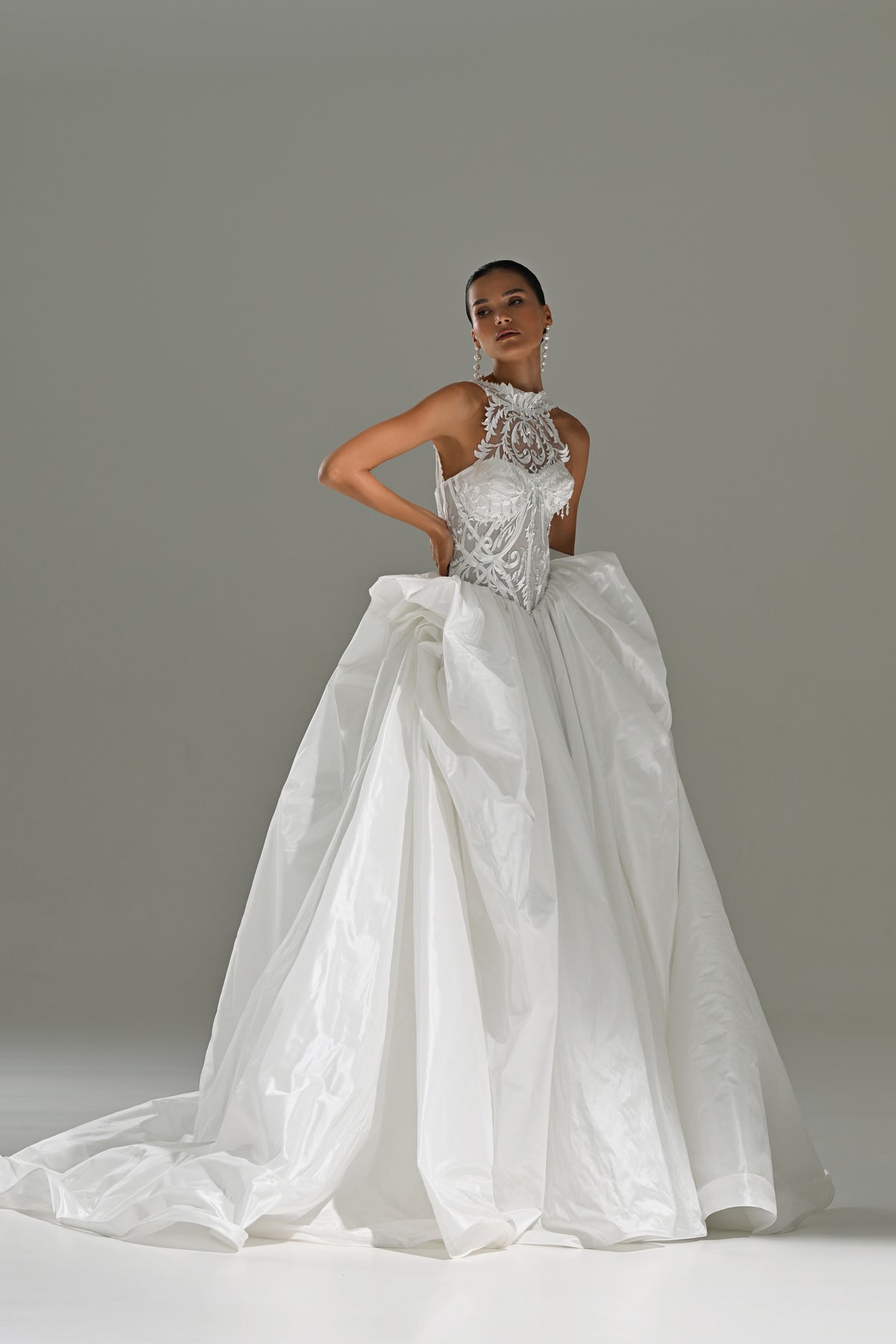 Taffeta ball gown wedding dress with lace corset, high collar and draped bow skirt – full-length front view