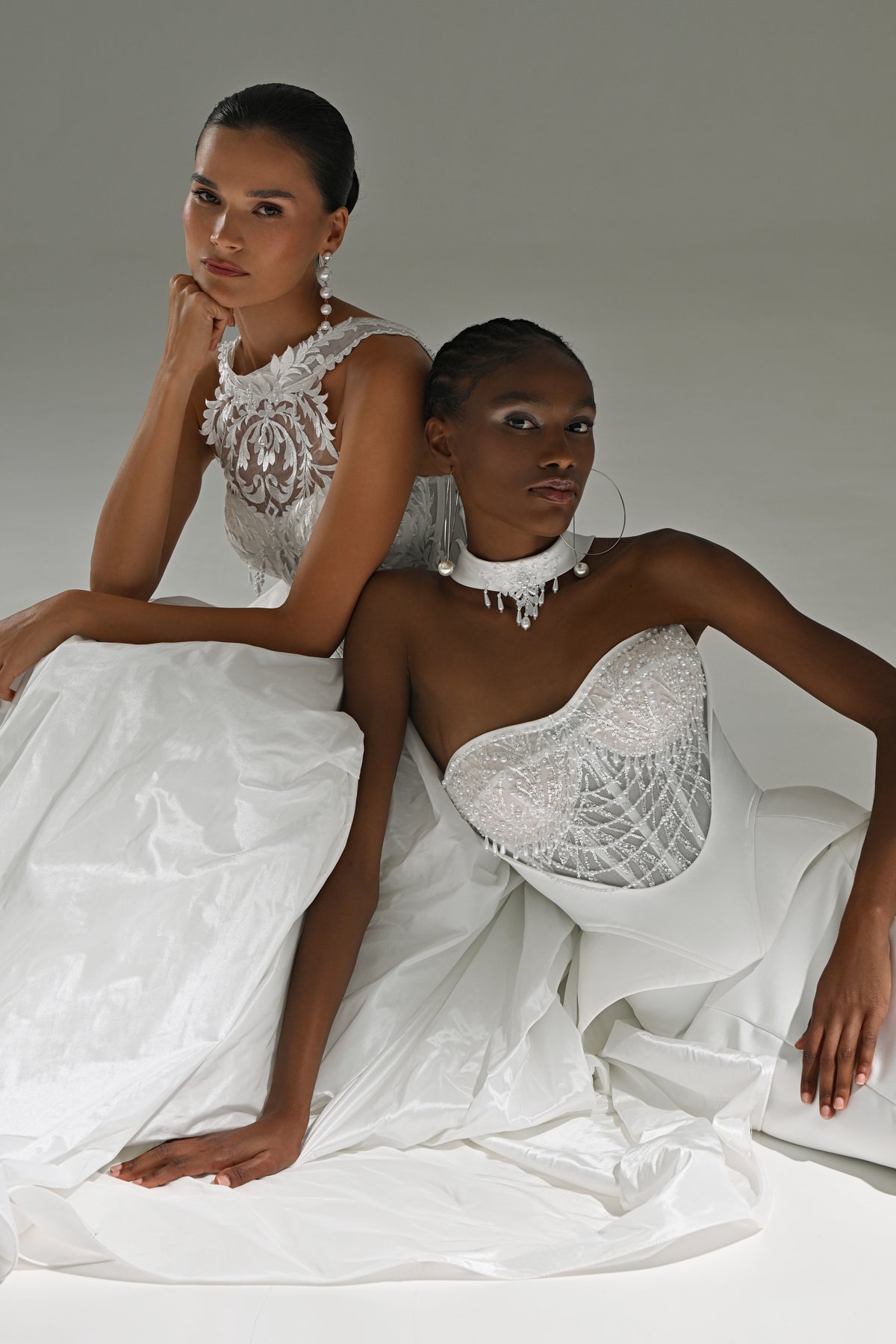 Taffeta ball gown wedding dress with lace high-collar corset – two brides posing together on the floor