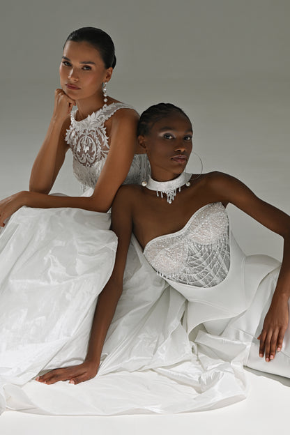 Taffeta ball gown wedding dress with lace high-collar corset – two brides posing together on the floor