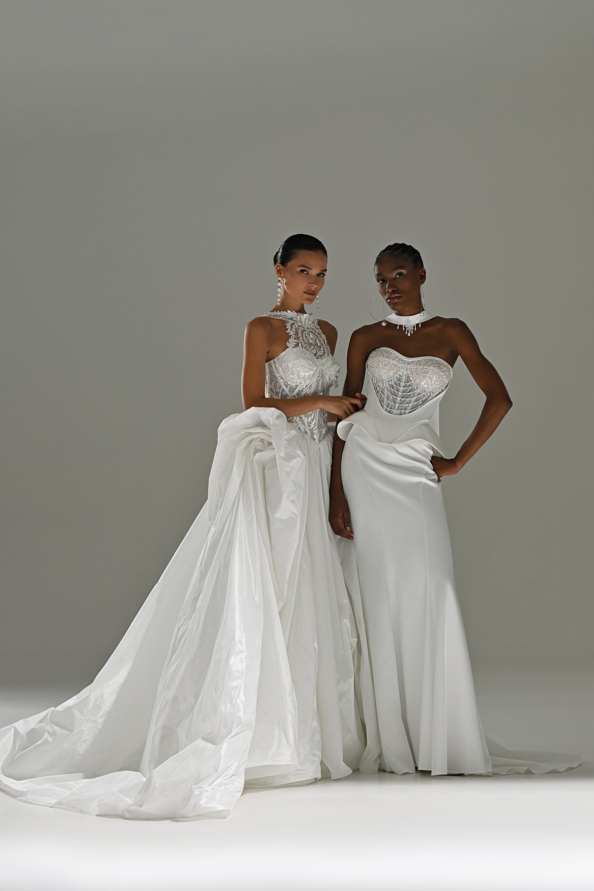 Taffeta ball gown wedding dress with lace high-collar corset – two brides standing, full-length view