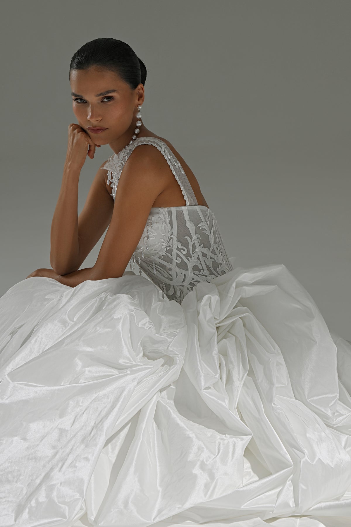 Taffeta ball gown wedding dress with lace high-collar corset – seated on the floor in the full skirt