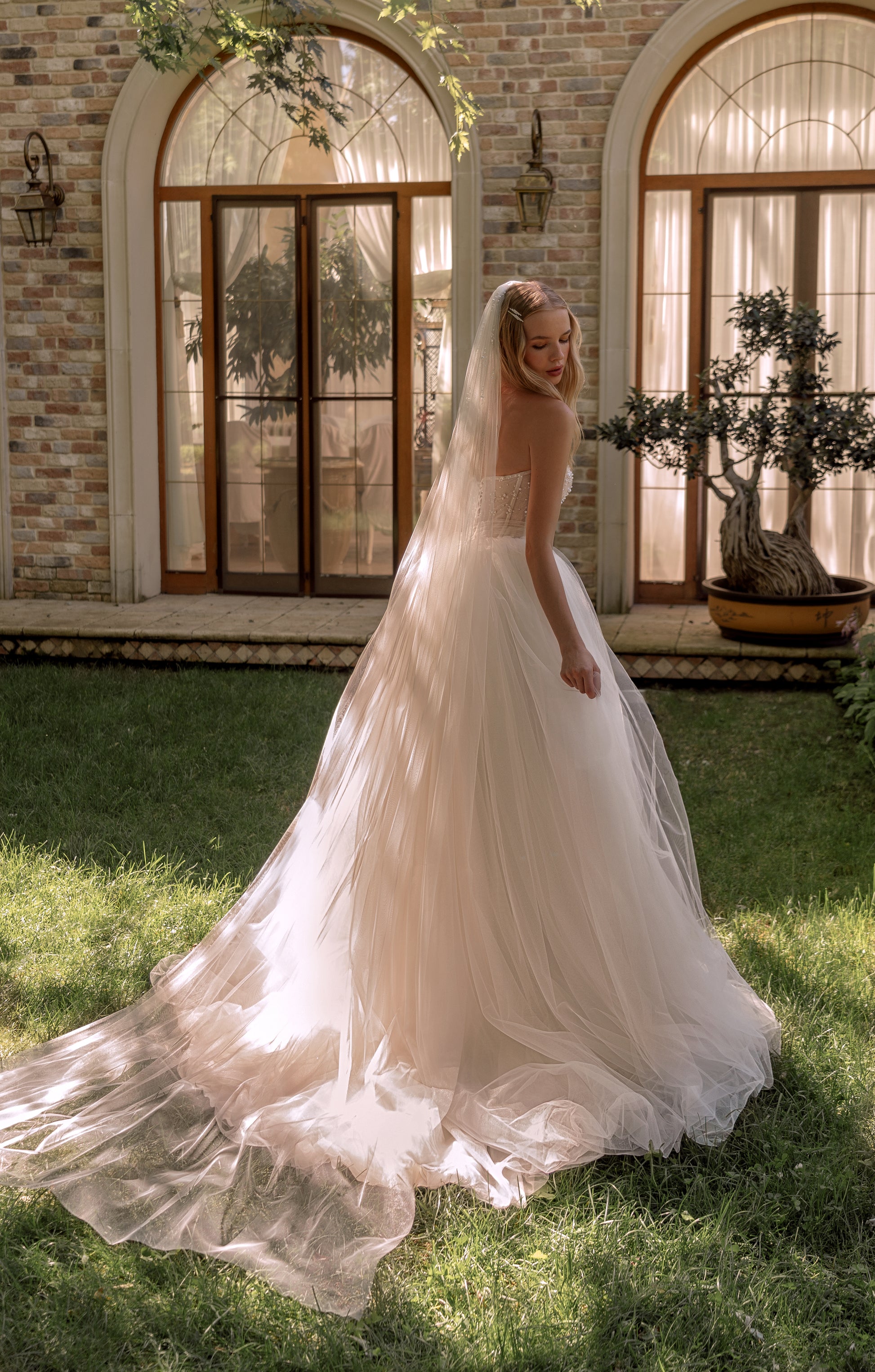 Princess wedding dress with pearl details and chapel train