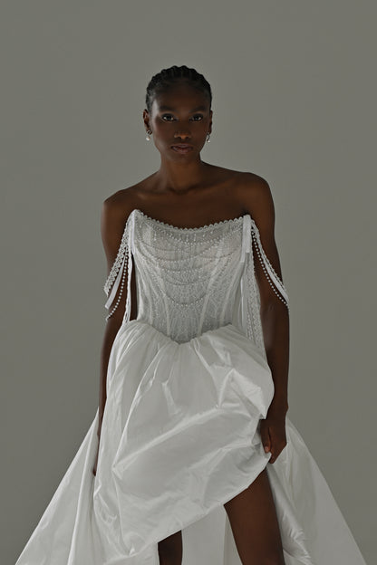 Taffeta wedding dress with lace corset and beaded fringe straps – front view lifting the high-slit overskirt