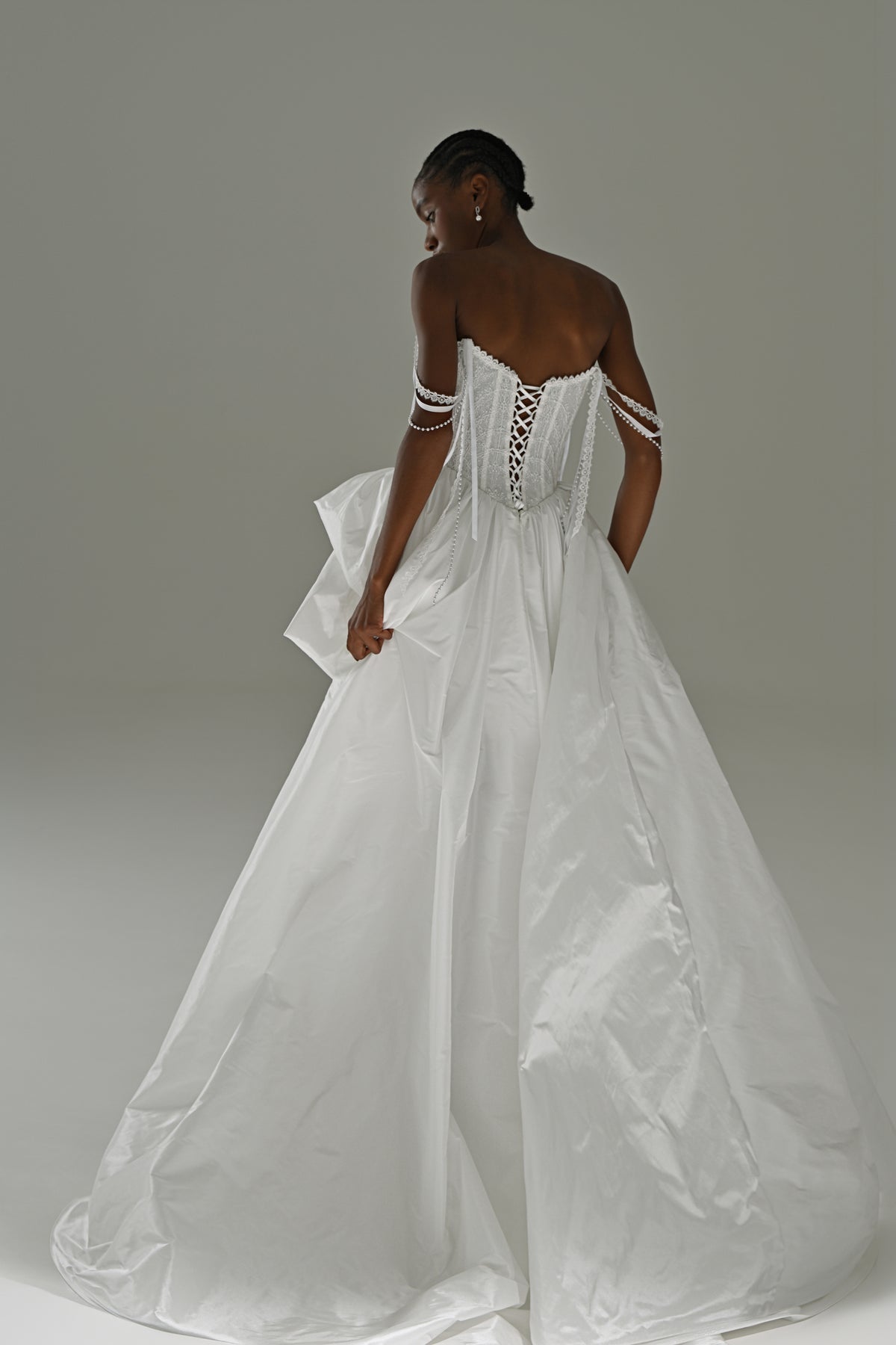 Taffeta wedding dress with lace corset – back view of the corset and full overskirt