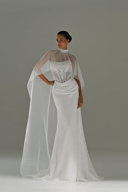 Lace sheath wedding dress with strapless corset bodice and sheer cape – front view with the high-neck cape