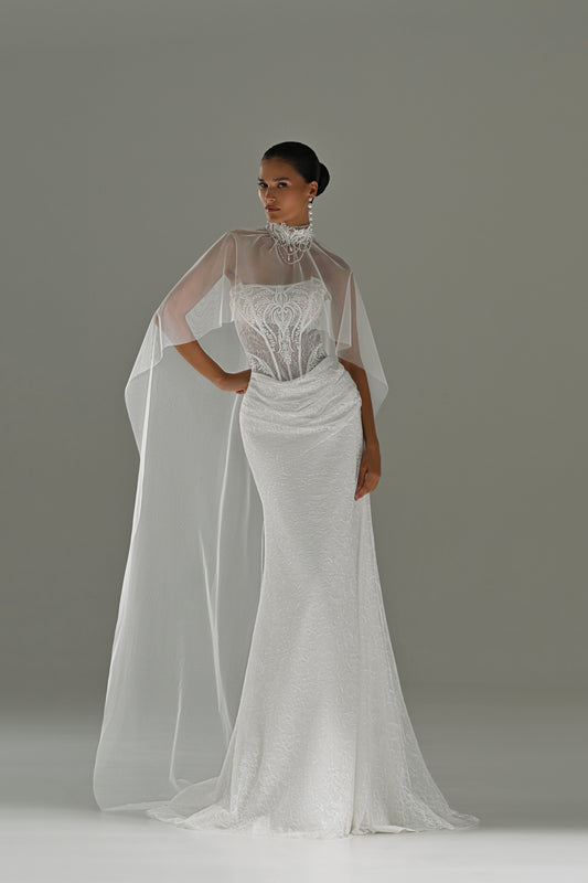 Lace sheath wedding dress with strapless corset bodice and sheer cape – front view with the high-neck cape