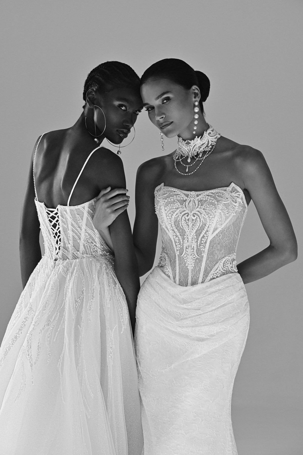 Lace sheath wedding dress with strapless corset – black and white close-up of the corset bodices