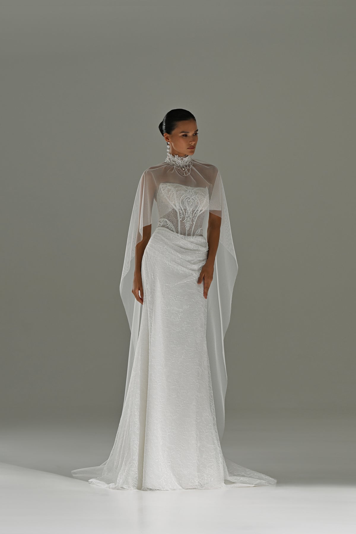 Lace sheath wedding dress with strapless corset bodice – full-length front view with sheer cape