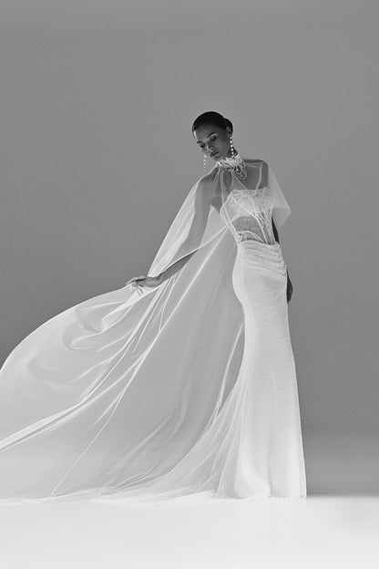 Lace sheath wedding dress with sheer cape – black and white view of the cape in motion