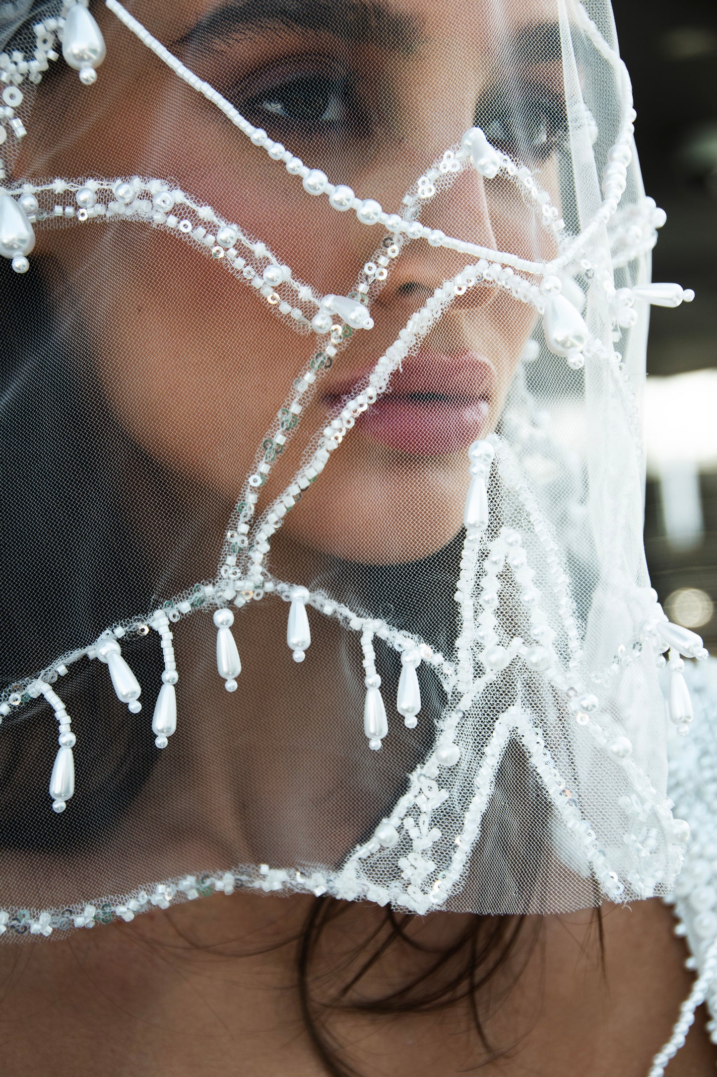 Sculpted beaded mermaid wedding gown with scoop neckline, pearl-inspired detailing, and soft tulle chapel train.