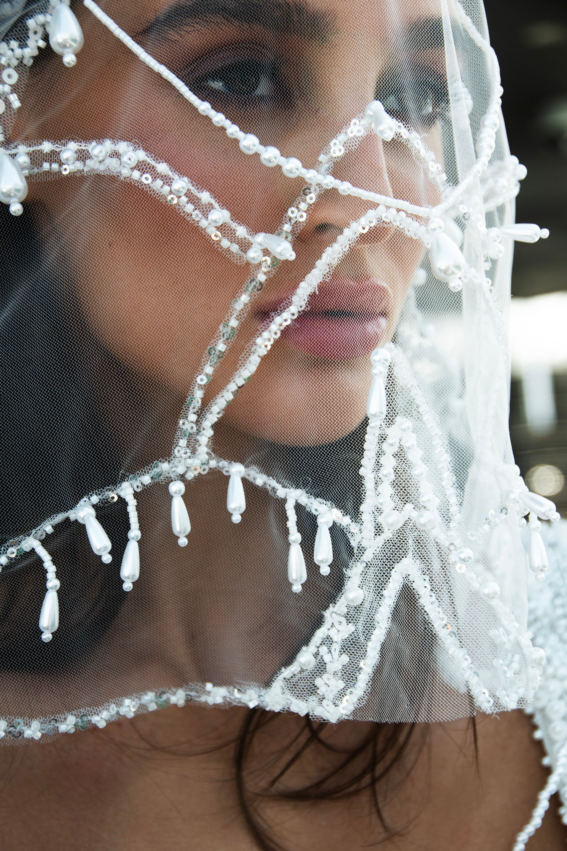 Sculpted beaded mermaid wedding gown with scoop neckline, pearl-inspired detailing, and soft tulle chapel train.