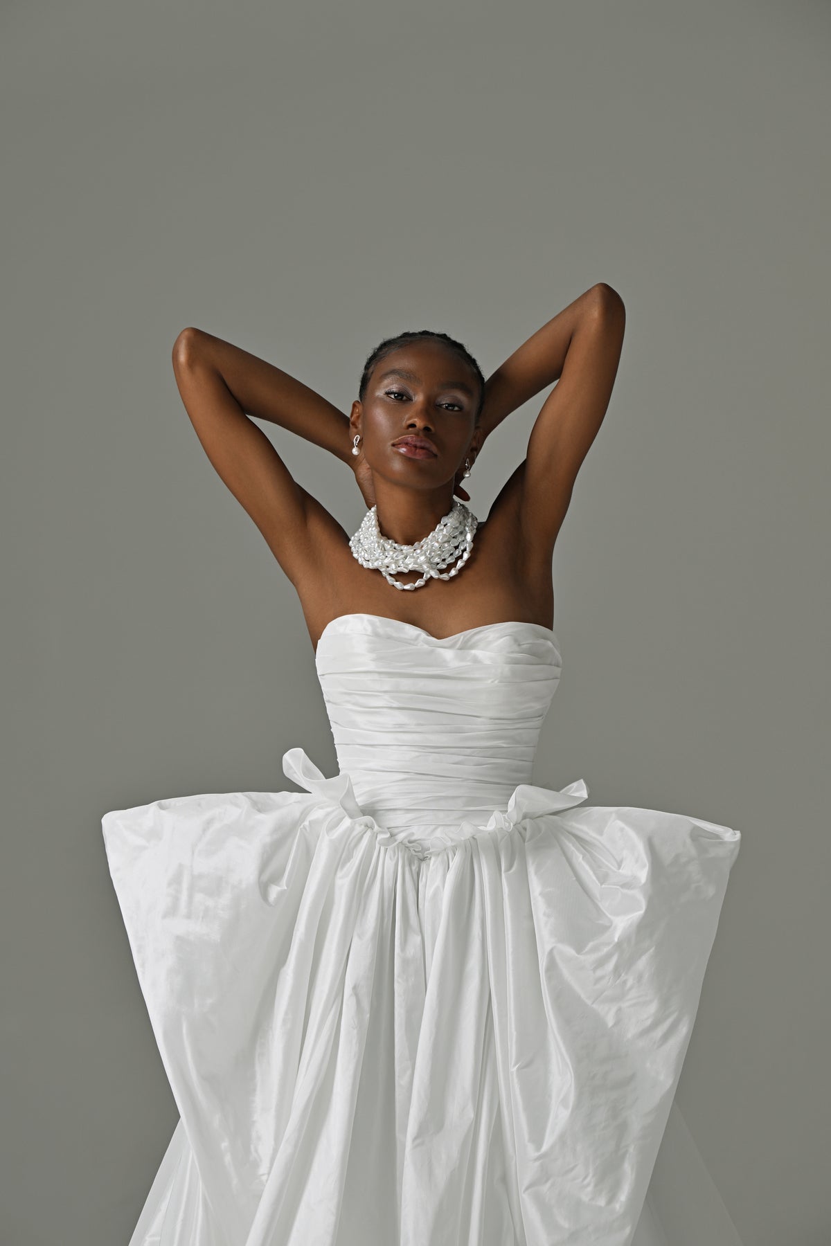 Strapless taffeta ball gown wedding dress – close-up of the ruched bodice and oversized waist bow