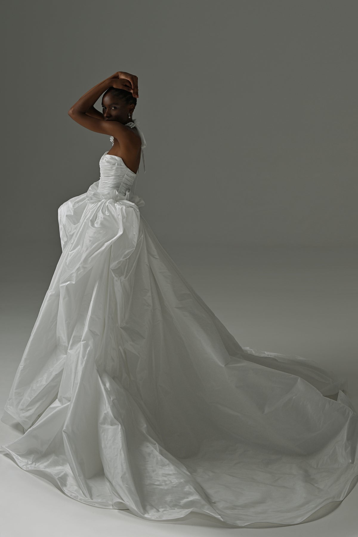 Taffeta ball gown wedding dress with oversized bow – side view of the full flowing skirt