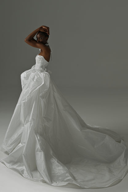 Taffeta ball gown wedding dress with oversized bow – side view of the full flowing skirt