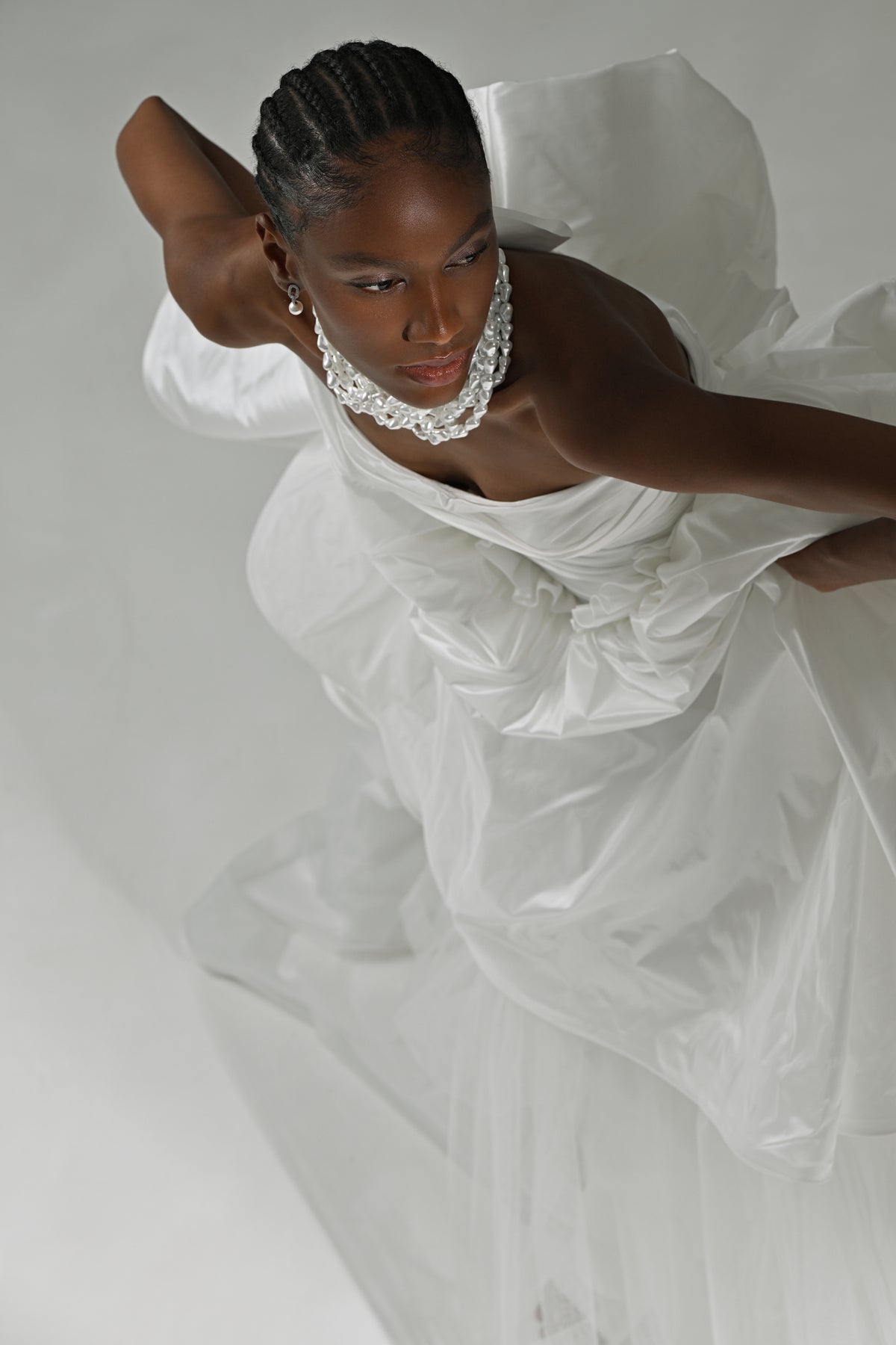 Strapless taffeta ball gown wedding dress – high-angle close-up of the ruched bodice and bow