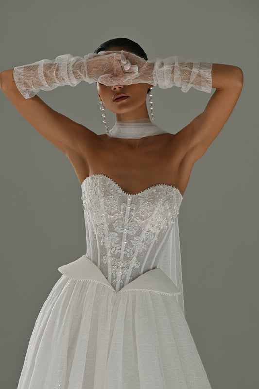 Strapless lace corset ball gown wedding dress with shimmer skirt – front close-up of the beaded corset with sheer gloves raised