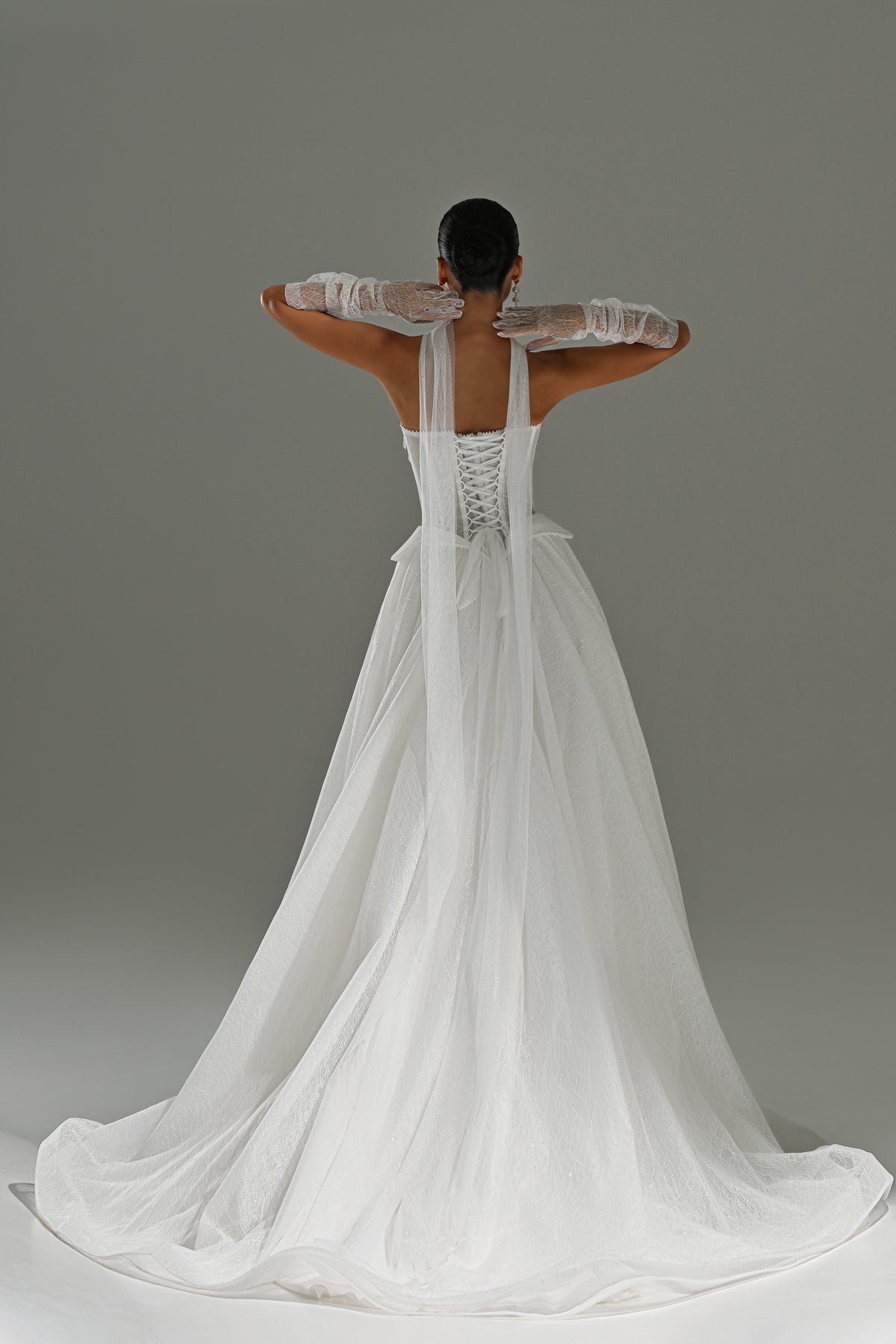 Strapless lace corset ball gown wedding dress with sheer scarf – back view with the sweeping train