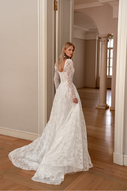 A-line wedding dress with long sleeves and open back.