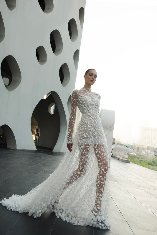 Modern 3D floral bridal mini gown with sheer long sleeves and detachable tulle overskirt.