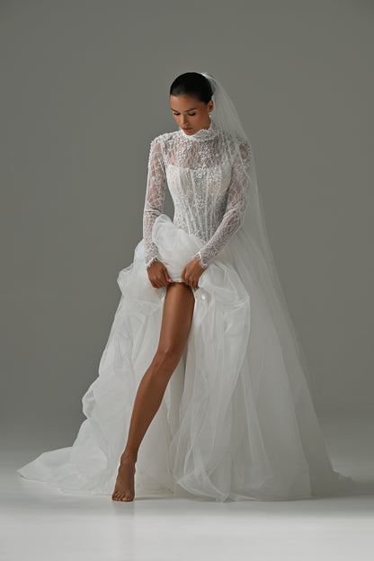 Lace high-neck wedding dress with tulle skirt – front view with the skirt lifted to show the leg slit