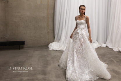 Sleeveless wedding dress with chapel train and sequin lace.