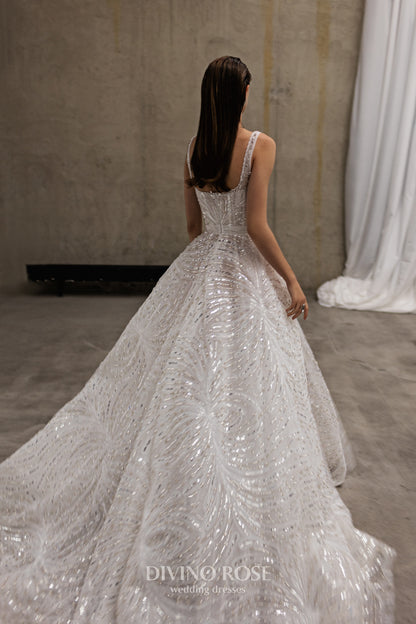 Sleeveless wedding dress with chapel train and sequin lace.