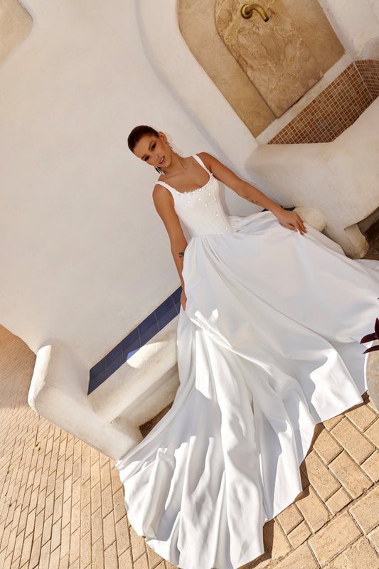 Sleeveless A-line Mikado bridal gown with wide straps, drop-down waist, zip closure, and chapel train. Classic wedding dress in timeless modern style.