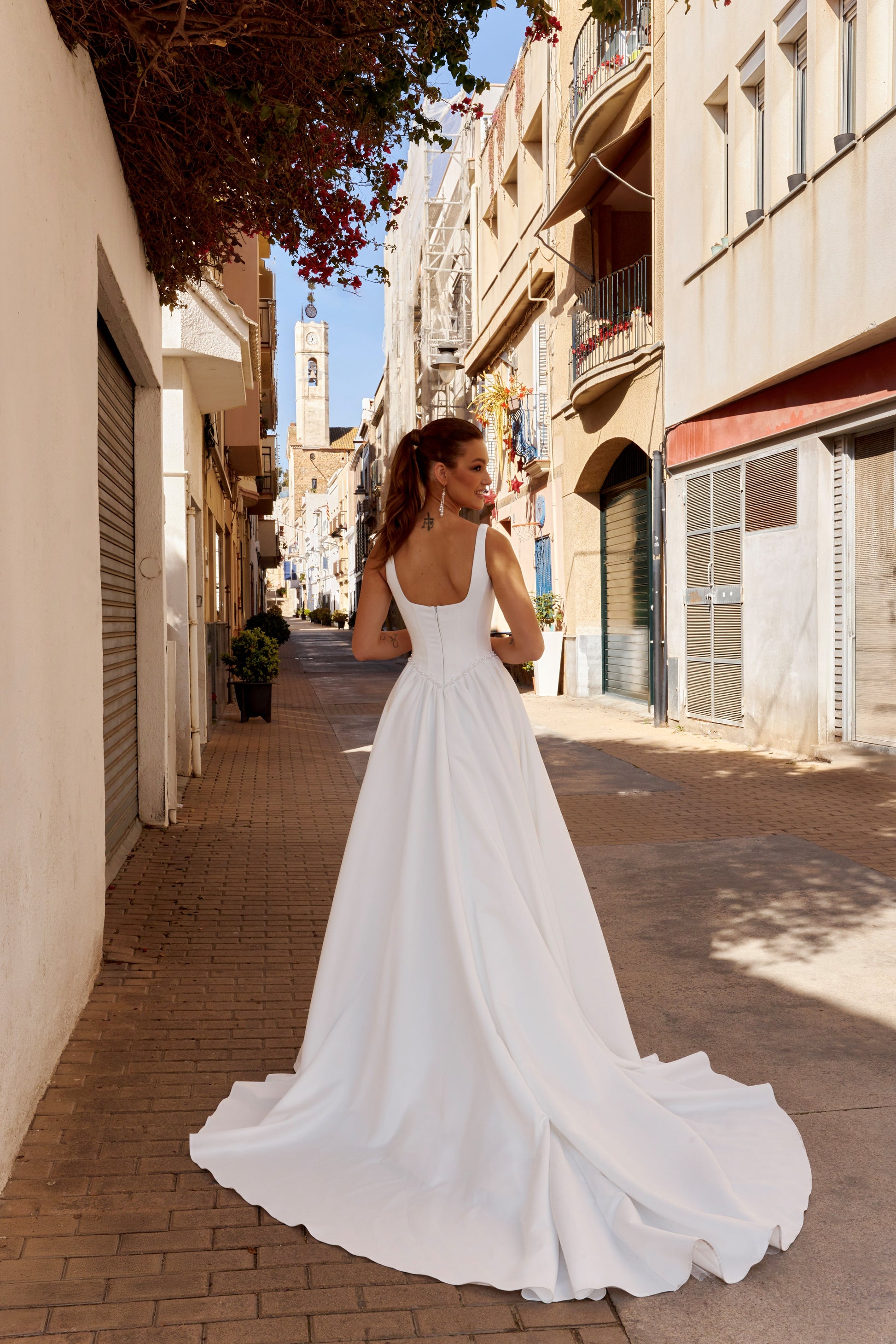 Sleeveless A-line Mikado bridal gown with wide straps, drop-down waist, zip closure, and chapel train. Classic wedding dress in timeless modern style.