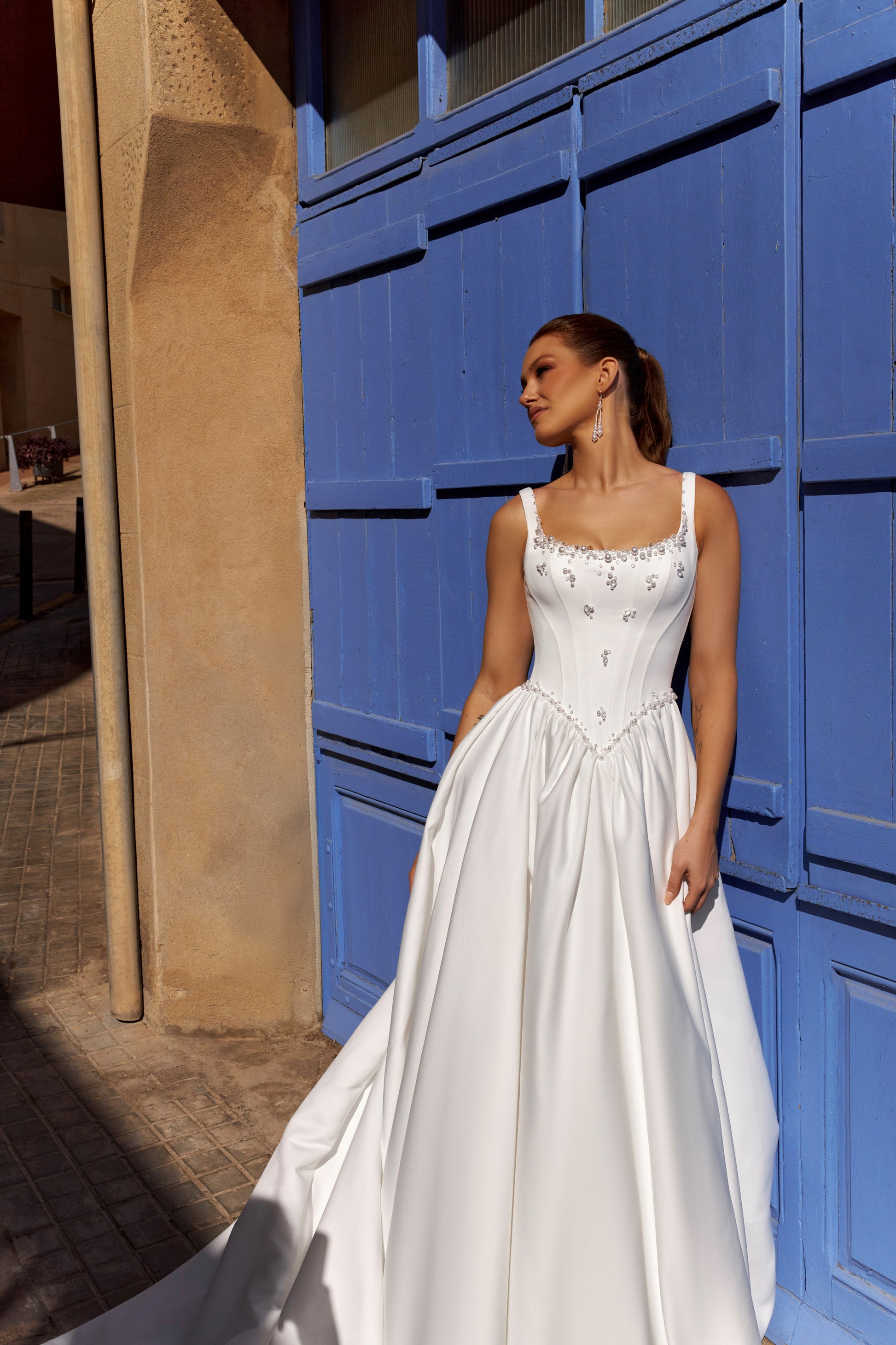 Sleeveless A-line Mikado bridal gown with wide straps, drop-down waist, zip closure, and chapel train. Classic wedding dress in timeless modern style.