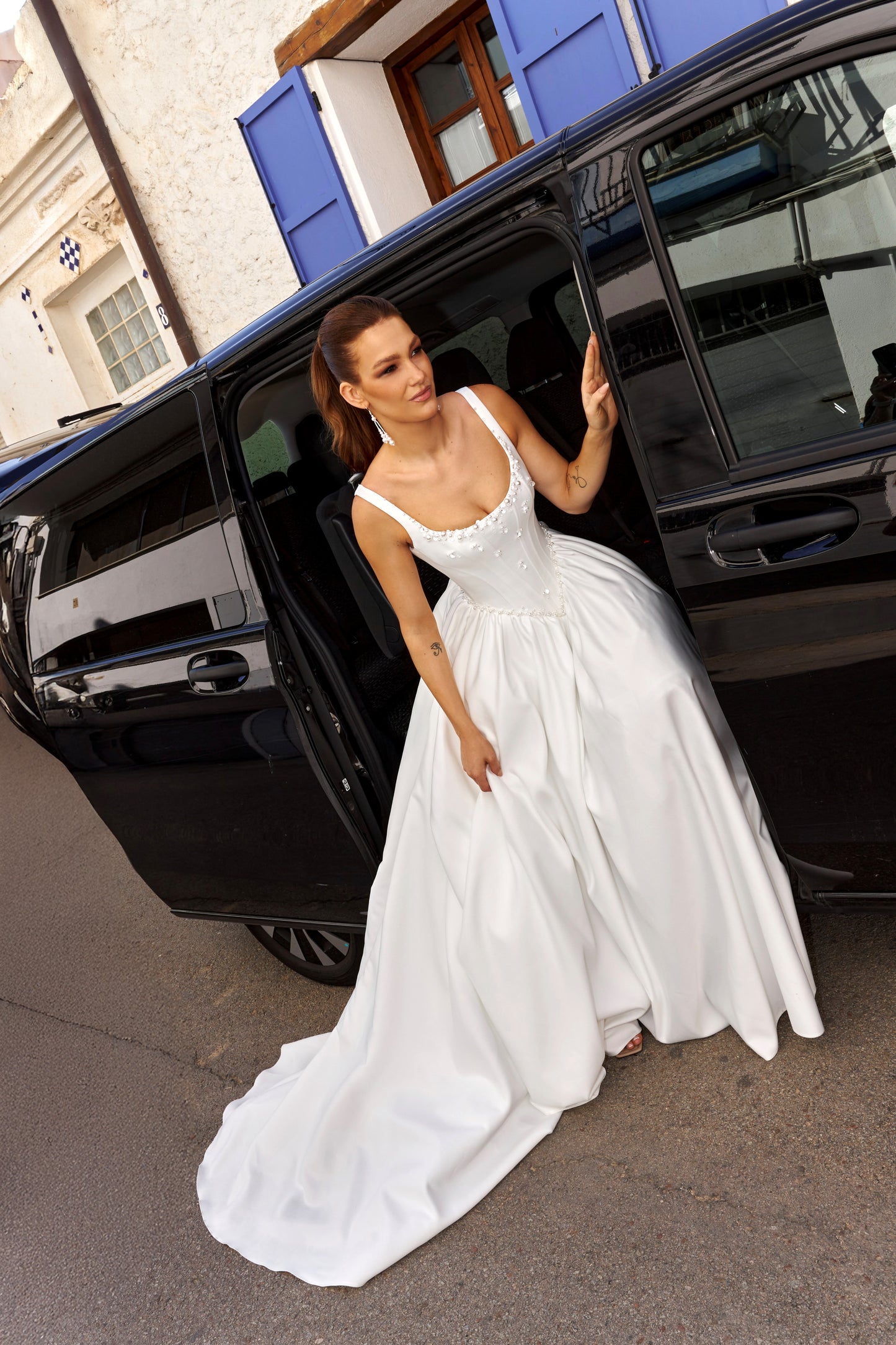 Sleeveless A-line Mikado bridal gown with wide straps, drop-down waist, zip closure, and chapel train. Classic wedding dress in timeless modern style.