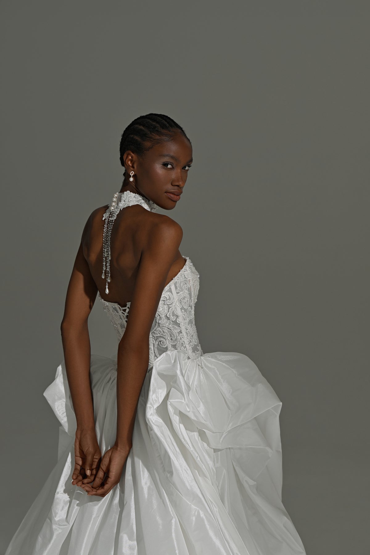 Taffeta ball gown wedding dress with lace corset – side view of the open lace back and bow detail