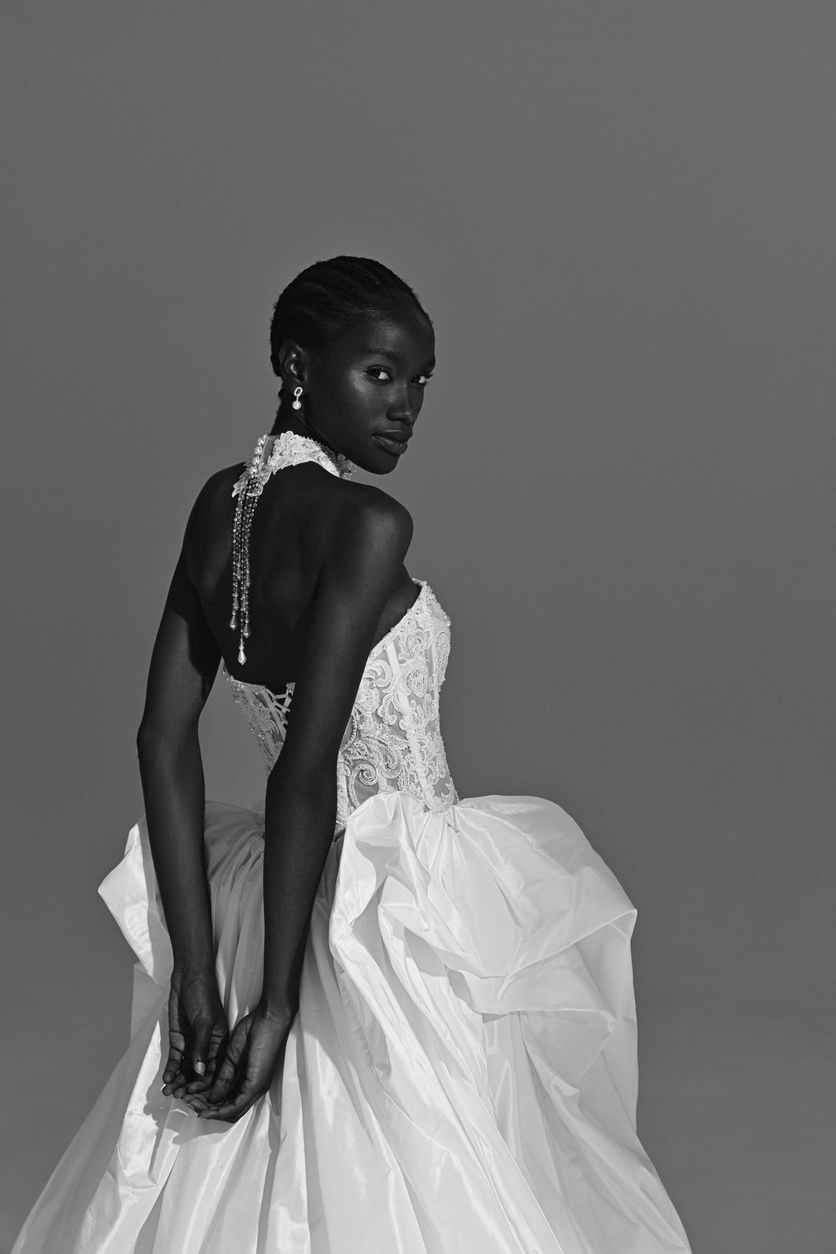Taffeta ball gown wedding dress – black and white side view of the open back and oversized bow