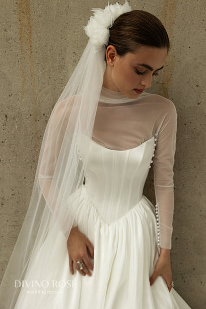 A-line wedding dress with boat neckline and corset back.